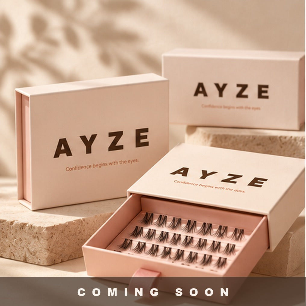 AYZE press-on lash boxes in blush pink, one drawer open showing rows of lashes